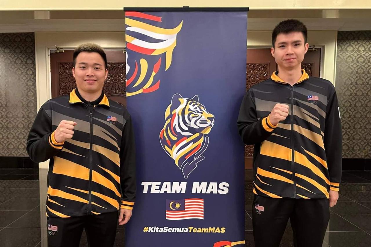 Malaysian Olympics contingent returns to tiger stripe design